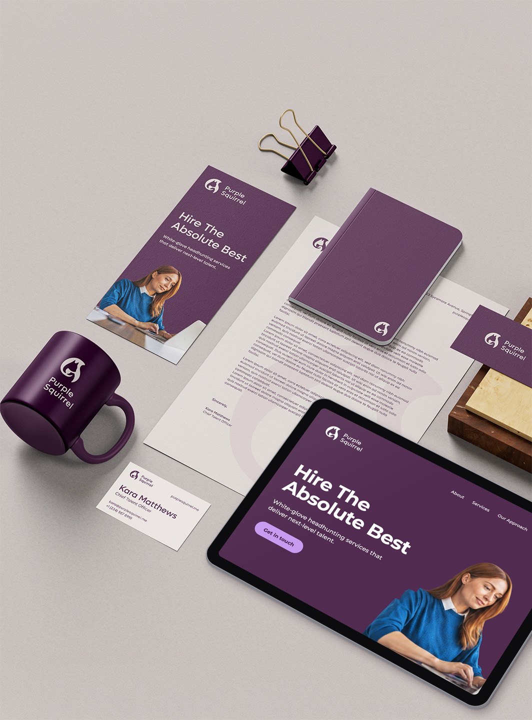 Purple Squirrel brand identity on stationery, a mug and a notebook, with its website shown on a tablet